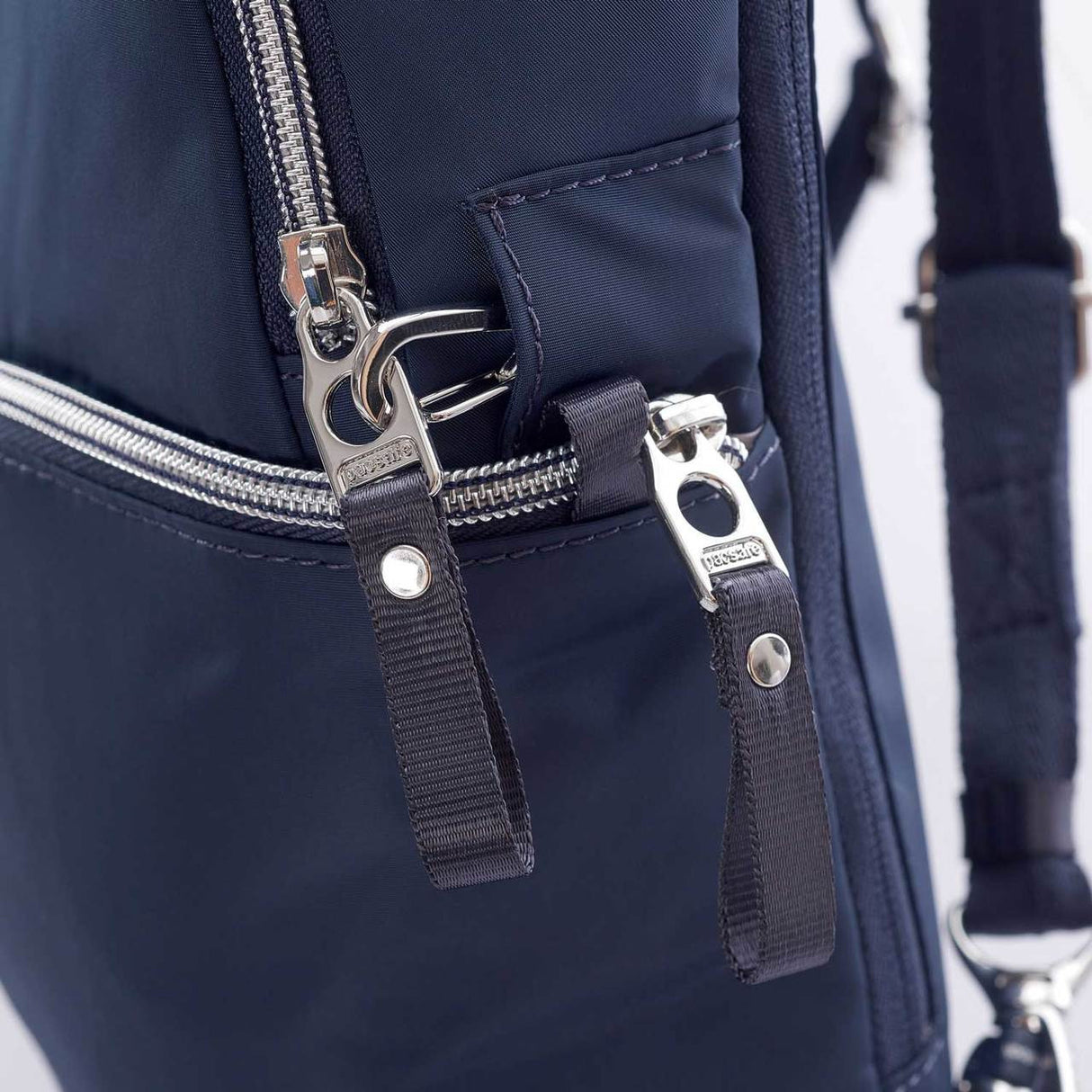 Pacsafe Stylesafe Sling Backpack, NAVY, zip clip and secure tab pull