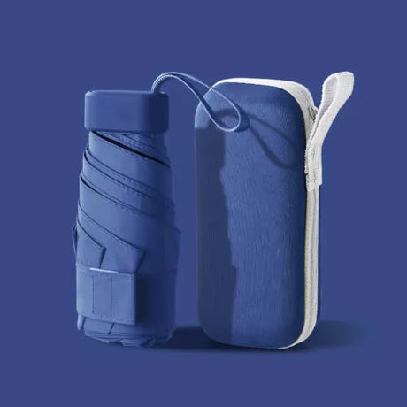 Dark blue folded compact travel umbrella beside its matching zip-up carry case