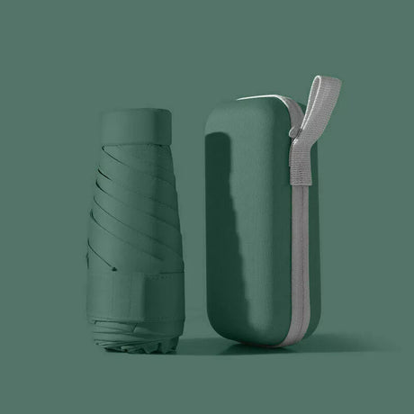 Green folded compact travel umbrella beside its matching zip-up carry case