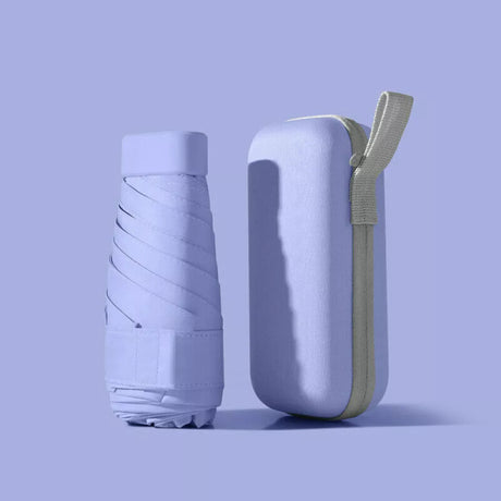 Purple folded compact travel umbrella beside its matching zip-up carry case