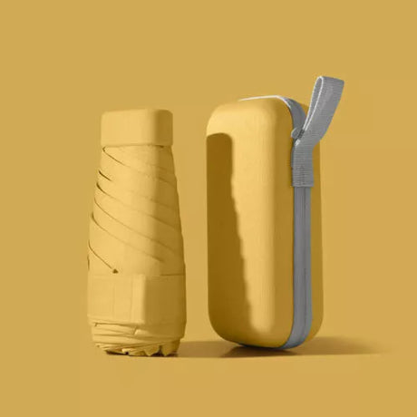 Yellow folded compact travel umbrella beside its matching zip-up carry case